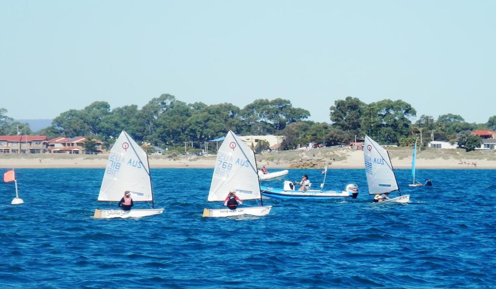 Outside assistance encouraged - Mandurah coach Ashley Jones helps the Optimist fleet hone its skills whilst racing.  © Annette Walker